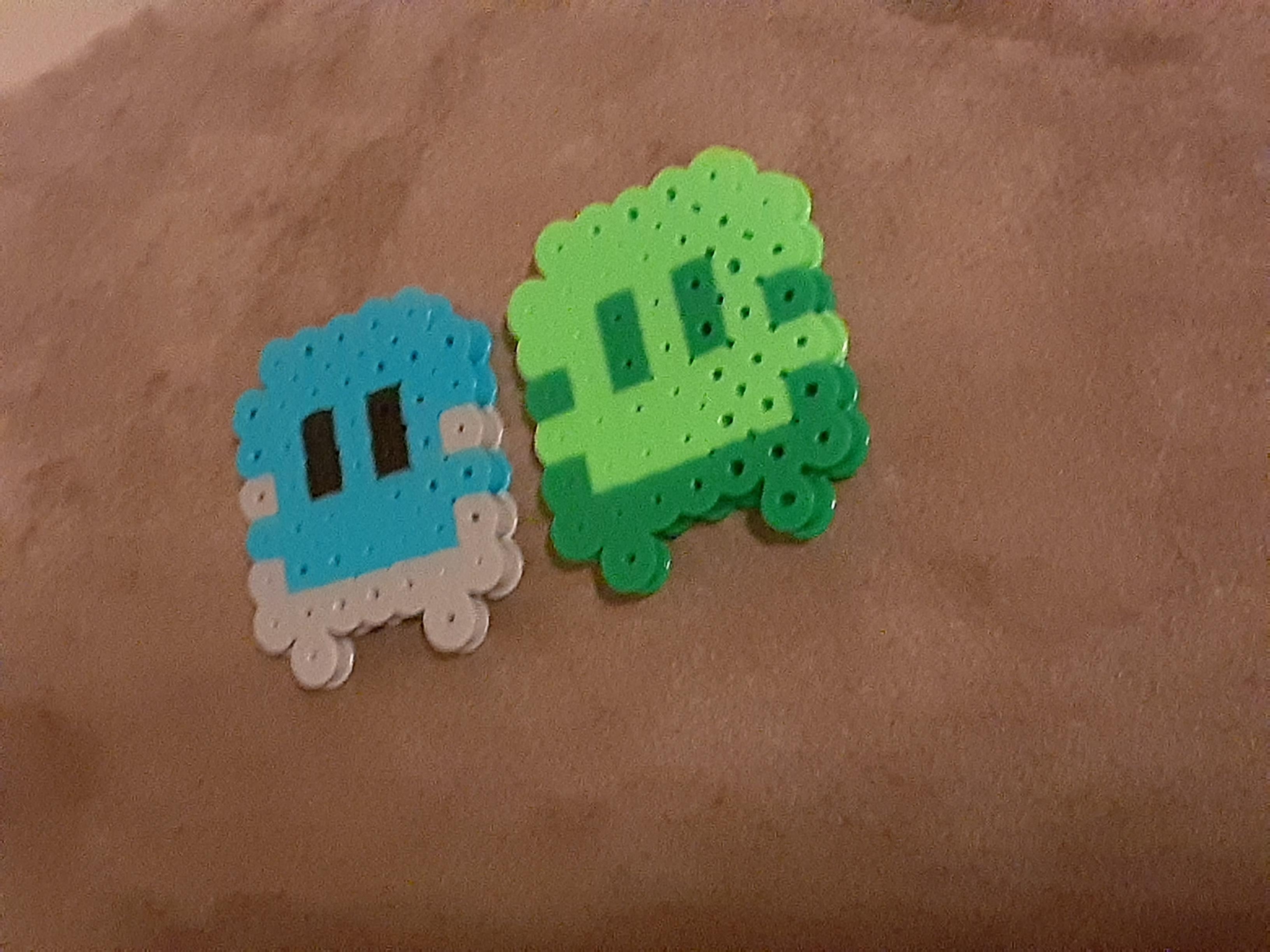 The main character of Just One Boss and their reflection recreated using Perler beads.