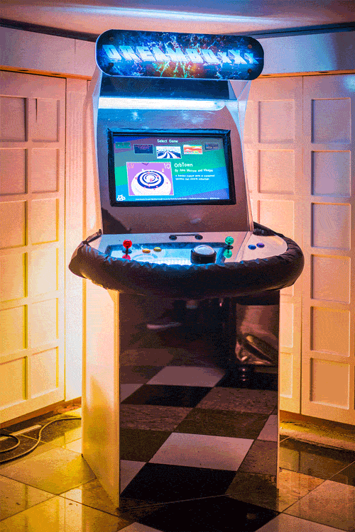 A glowing reflective arcade cabinet entitled "DreamBoxXx".