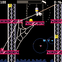 A spider constructs a web between the moving girders of a construction site.