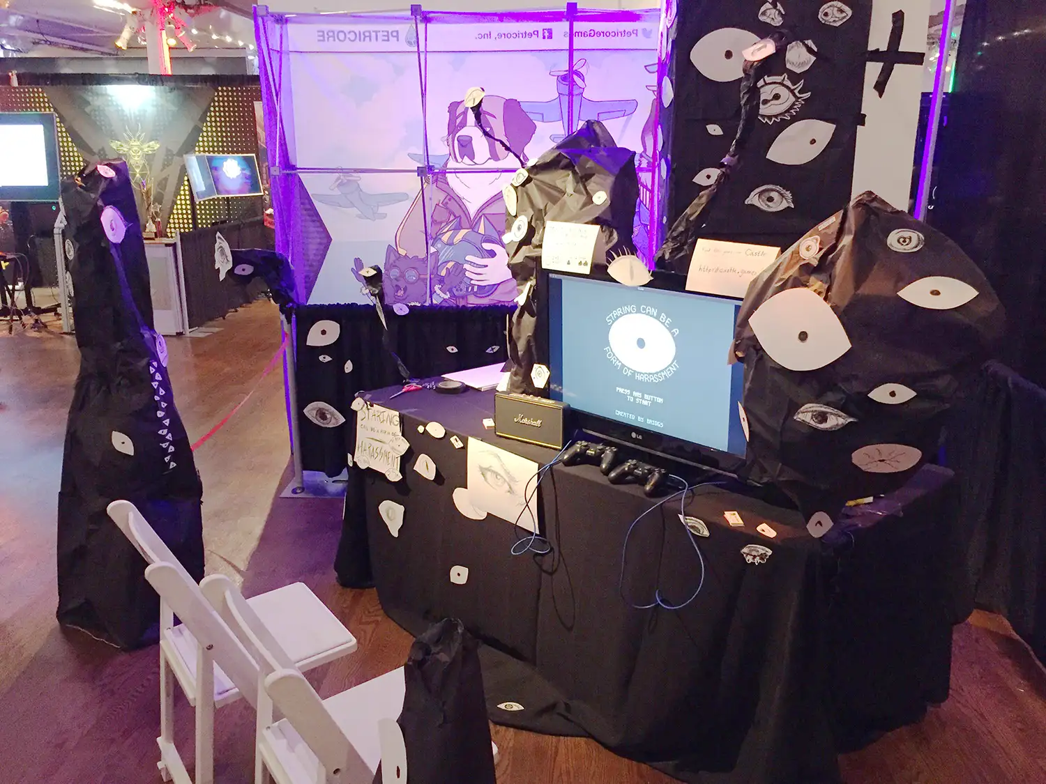 An event booth decorated with hand-drawn eyeballs.